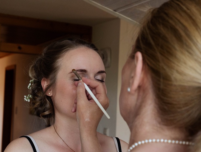 Heike Weigand schminkt eine Braut